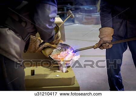 Workers pouring aluminium alloy sample in precision casting factory View Large Photo Image Stock Photo - Workers pouring aluminium alloy sample in precision casting factory. Fotosearch