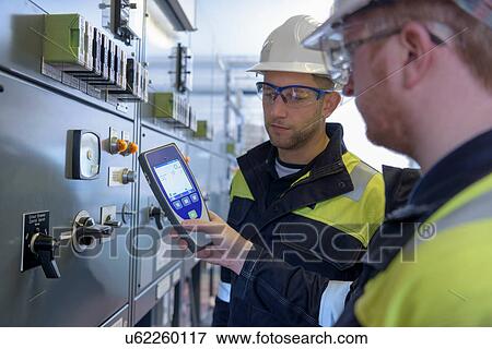 Workers testing for noise in electricity substation View Large Photo Image Stock Photo - Workers testing for noise in electricity substation. Fotosearch