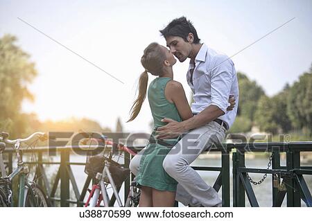 Young couple hugging, kissing, Turin, Piedmont, Italy View Large Photo Image Stock Photo - Young couple hugging, kissing, Turin, Piedmont, Italy. Fotosearch