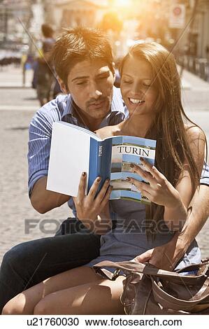 Young couple looking at guidebook, Turin, Piedmont, Italy View Large Photo Image Stock Image - Young couple looking at guidebook, Turin, Piedmont, Italy. Fotosearch