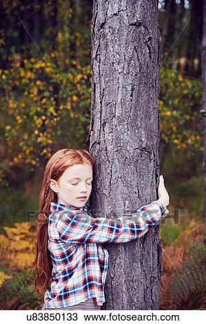 Young girl, hugging tree View Large Photo Image Stock Image - Young girl, hugging tree. Fotosearch