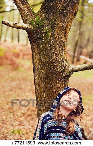 Young girl, leaning against tree, eyes closed View Large Photo Image Stock Photo - Young girl, leaning against tree, eyes closed. Fotosearch