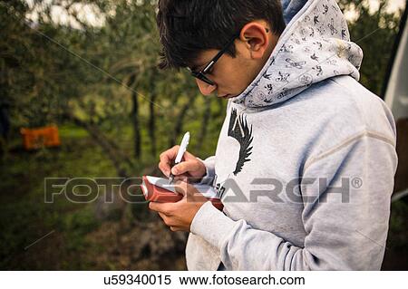 Young man harvesting at vineyard writing notes View Large Photo Image Stock Photography - Young man harvesting at vineyard writing notes. Fotosearch