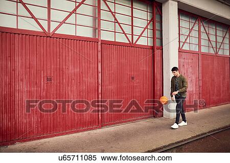 Young man in urban area, bouncing basketball, Bristol, UK View Large Photo Image Stock Photography - Young man in urban area, bouncing basketball, Bristol, UK. Fotosearch