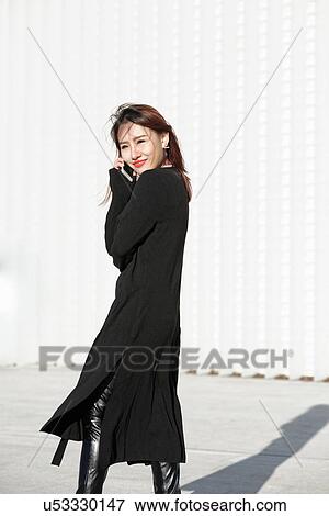 Young woman against backdrop of textured wall, Milan, Italy View Large Photo Image Stock Photo - Young woman against backdrop of textured wall, Milan, Italy. Fotosearch