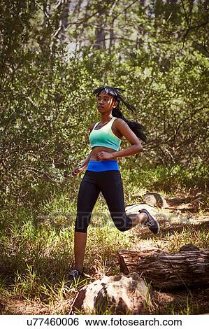 Young woman exercising, running, in rural setting View Large Photo Image Stock Photograph - Young woman exercising, running, in rural setting. Fotosearch