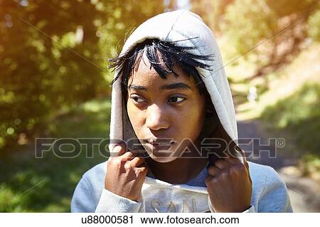 Young woman in rural setting, wearing hooded sweatshirt View Large Photo Image Stock Image - Young woman in rural setting, wearing hooded sweatshirt. Fotosearch