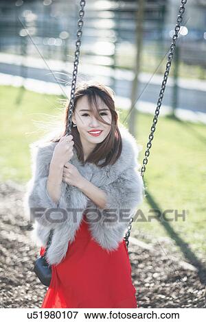 Young woman on swing, Milan, Italy View Large Photo Image Stock Photo - Young woman on swing, Milan, Italy. Fotosearch