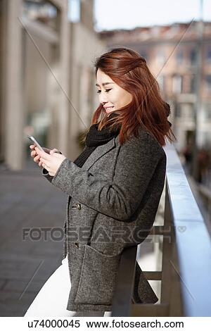 Young woman texting, Milan, Italy View Large Photo Image Stock Photography - Young woman texting, Milan, Italy. Fotosearch
