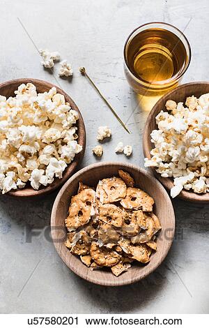 Bowls of popcorn, pretzel crackers and drink, overhead view View Large Photo Image Stock Image - Bowls of popcorn, pretzel crackers and drink, overhead view. Fotosearch