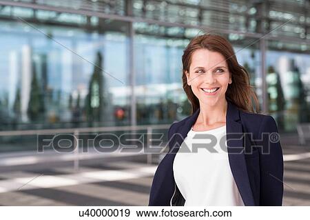 Stock Photo - Businesswoman outside airport. Fotosearch