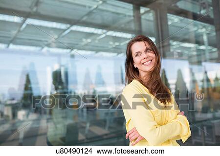 Businesswoman with arm folded outside airport View Large Photo Image Picture - Businesswoman with arm folded outside airport. Fotosearch