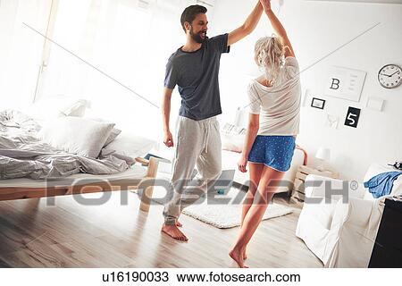 Couple in bedroom, wearing pyjamas, dancing View Large Photo Image Stock Image - Couple in bedroom, wearing pyjamas, dancing. Fotosearch