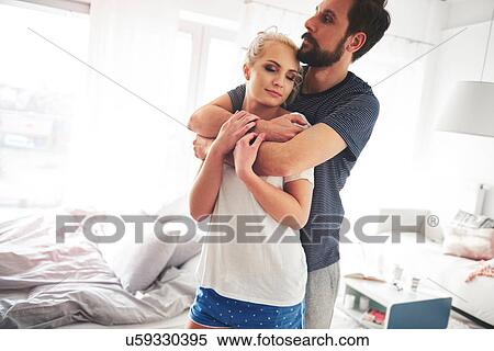 Couple in bedroom, wearing pyjamas, hugging View Large Photo Image Stock Photography - Couple in bedroom, wearing pyjamas, hugging. Fotosearch