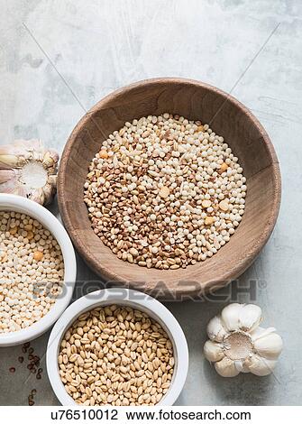 Different types of grains in bowls, garlic bulbs beside bowls, overhead view View Large Photo Image Stock Image - Different types of grains in bowls, garlic bulbs beside bowls, overhead view. Fotosearch