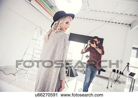 Male photographer photographing female model on studio white background View Large Photo Image Stock Image - Male photographer photographing female model on studio white background. Fotosearch