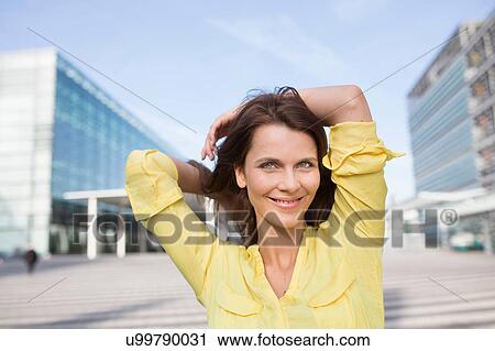 Portrait of businesswoman with hands behind head at airport View Large Photo Image Stock Image - Portrait of businesswoman with hands behind head at airport. Fotosearch