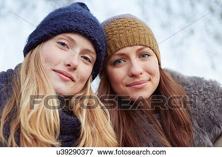 Portrait of two female friends outdoors, wearing knitted hats View Large Photo Image Stock Photo - Portrait of two female friends outdoors, wearing knitted hats. Fotosearch