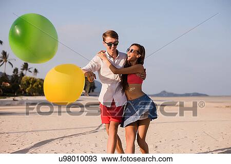 Young couple on beach playing with balloons, Koh Samui, Thailand View Large Photo Image Stock Image - Young couple on beach playing with balloons, Koh Samui, Thailand. Fotosearch