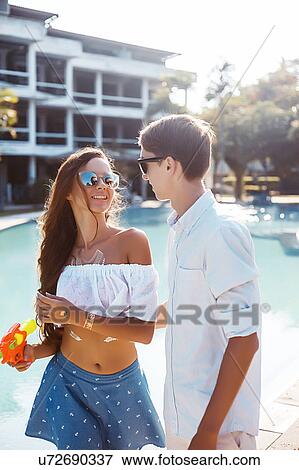 Stock Photo - Young couple on poolside, Koh Samui, Thailand. Fotosearch
