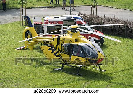 Stock Photo - Air ambulance (Adac) helicopter and ambulance, Gera, Germany, May 2016.. Fotosearch