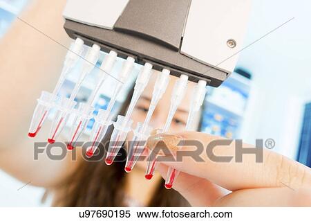 Stock Photography - Chemistry student using multi pipette. Fotosearch