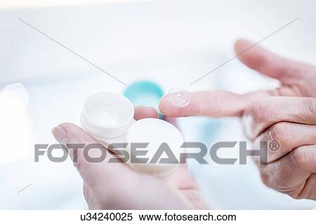 Close-up of person holding contact lens case. View Large Photo Image Stock Photography - Close-up of person holding contact lens case.. Fotosearch