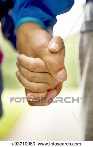 Stock Image - Couple holding hands. Fotosearch