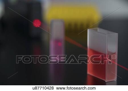 Stock Photo - Cuvette with red laser beam.. Fotosearch