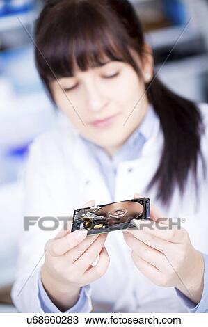 Female electronics student holding hard disc drive View Large Photo Image Stock Image - Female electronics student holding hard disc drive. Fotosearch