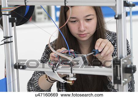 Stock Photo - Female electronics student in laboratory. Fotosearch
