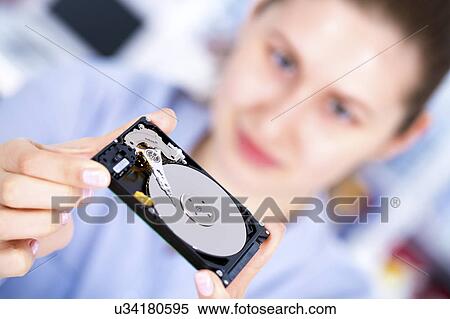 Female engineer holding hard disc drive View Large Photo Image Stock Photography - Female engineer holding hard disc drive. Fotosearch