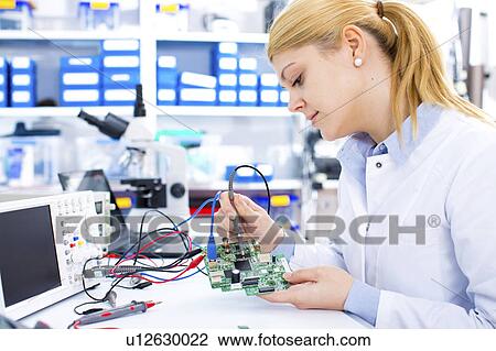 Female engineer soldering a circuit board View Large Photo Image Stock Image - Female engineer soldering a circuit board. Fotosearch