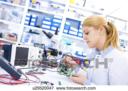 Female engineer soldering a circuit board View Large Photo Image Stock Photo - Female engineer soldering a circuit board. Fotosearch