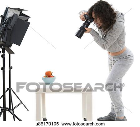 Female photographer in studio shooting still life View Large Photo Image Stock Photography - Female photographer in studio shooting still life. Fotosearch