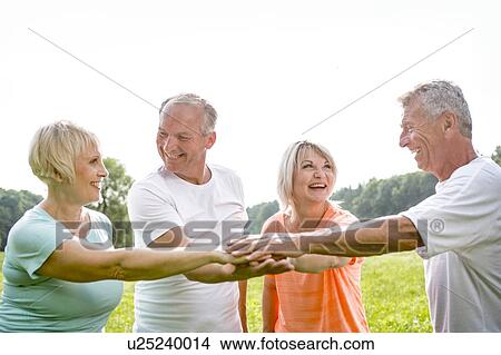 Four people in circle touching hands View Large Photo Image Picture - Four people in circle touching hands. Fotosearch