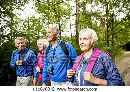 Stock Image - Four people on hike. Fotosearch