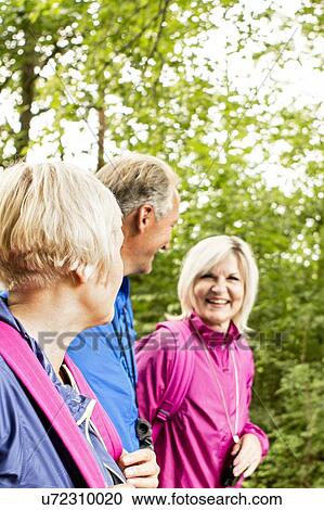 Stock Image - Four people on hike. Fotosearch