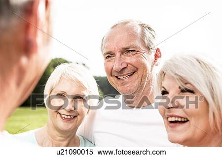 Stock Photography - Four people smiling. Fotosearch