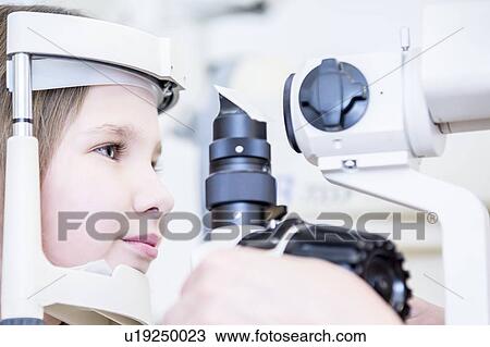 Stock Image - Girl having eye examination. Fotosearch