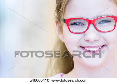 Girl trying on glasses View Large Photo Image Stock Image - Girl trying on glasses. Fotosearch