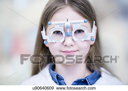 Stock Photo - Girl wearing trial frame. Fotosearch