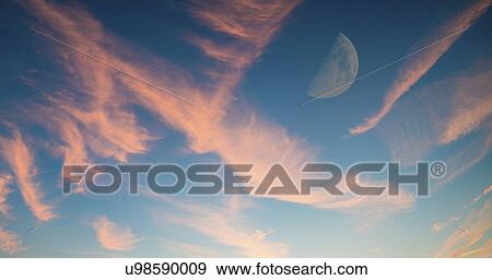Stock Photo - Half moon in sky with pink clouds.. Fotosearch