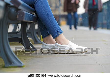 Legs of a girl in a summer town dressed in sneakers View Large Photo Image Picture - Legs of a girl in a summer town dressed in sneakers. Fotosearch