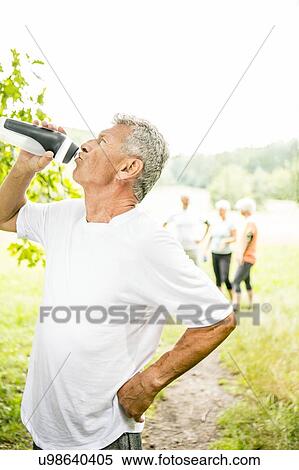 Man drinking water from sports bottle View Large Photo Image Stock Photography - Man drinking water from sports bottle. Fotosearch