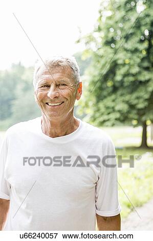 Stock Photo - Man in white t-shirt smiling. Fotosearch
