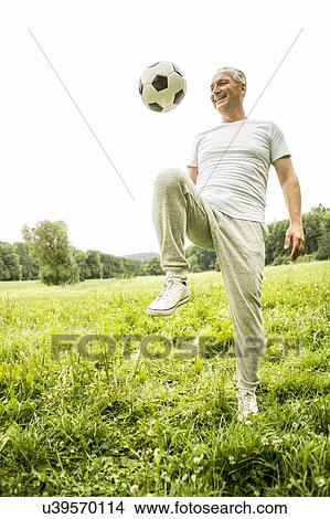 Man playing football View Large Photo Image Picture - Man playing football. Fotosearch