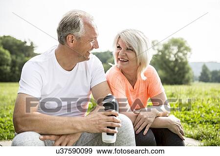 Mature couple sitting outdoors resting View Large Photo Image Stock Photo - Mature couple sitting outdoors resting. Fotosearch