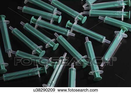 Stock Photo - Medical syringes against black background.. Fotosearch