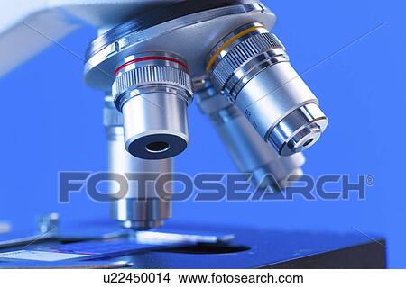 Picture - Microscope against blue background.. Fotosearch